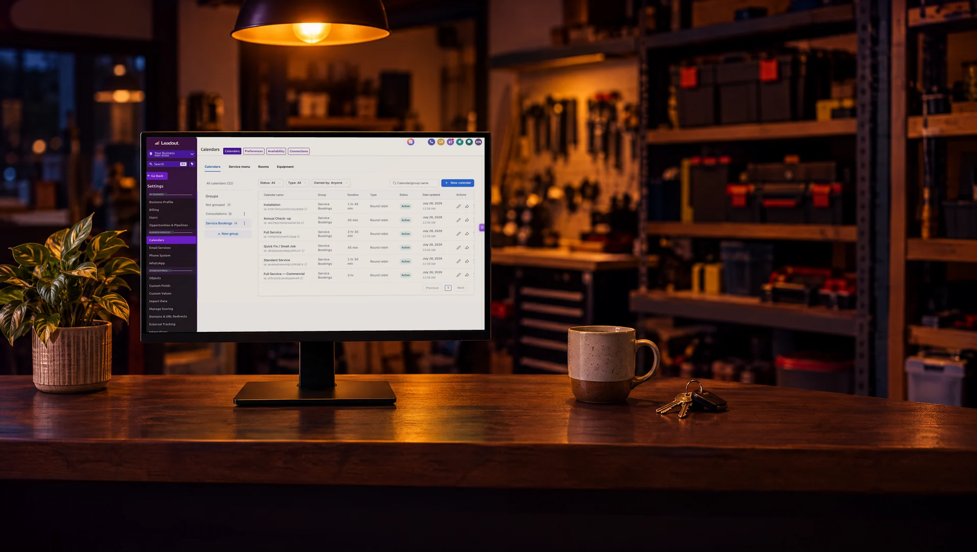 A shop counter with a monitor showing booking calendars